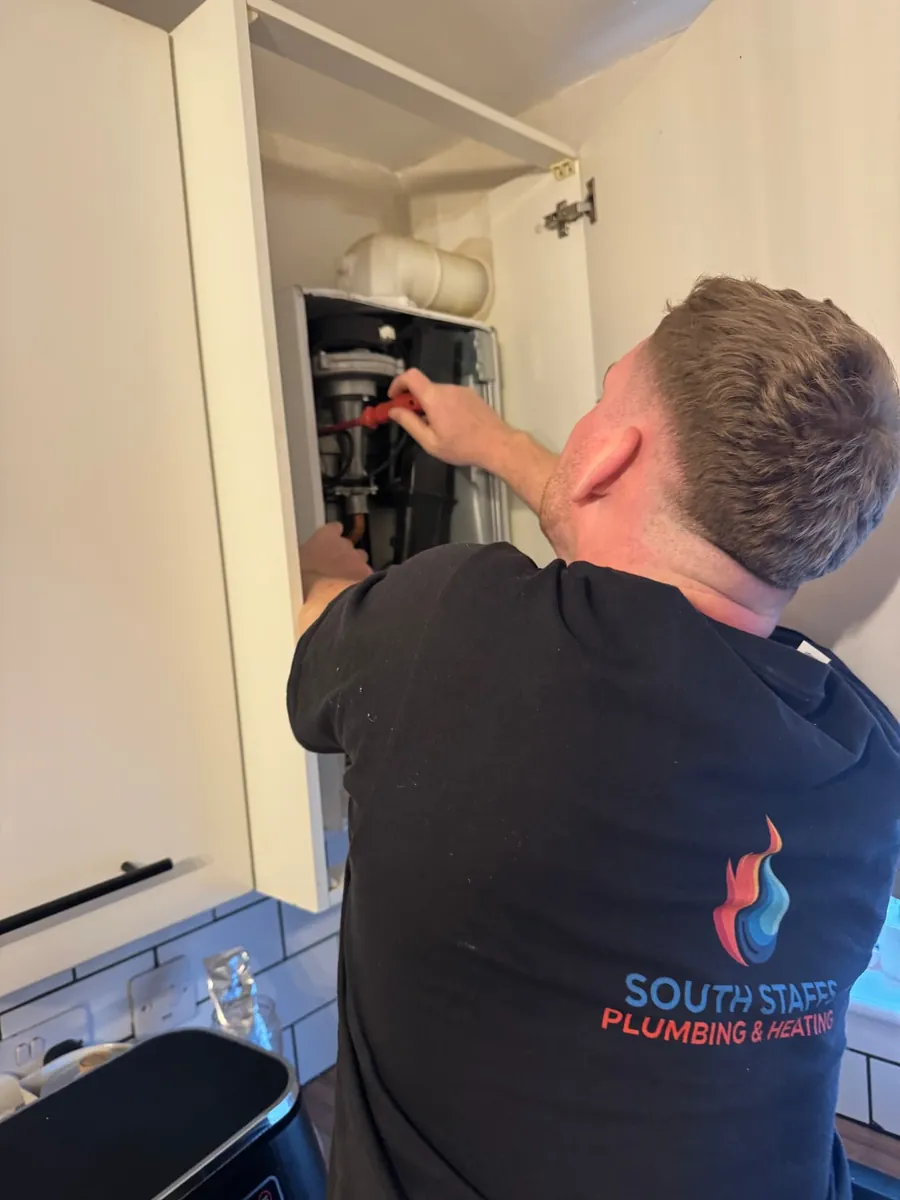James Robb of South Staffs Plumbing & Heating working on a boiler